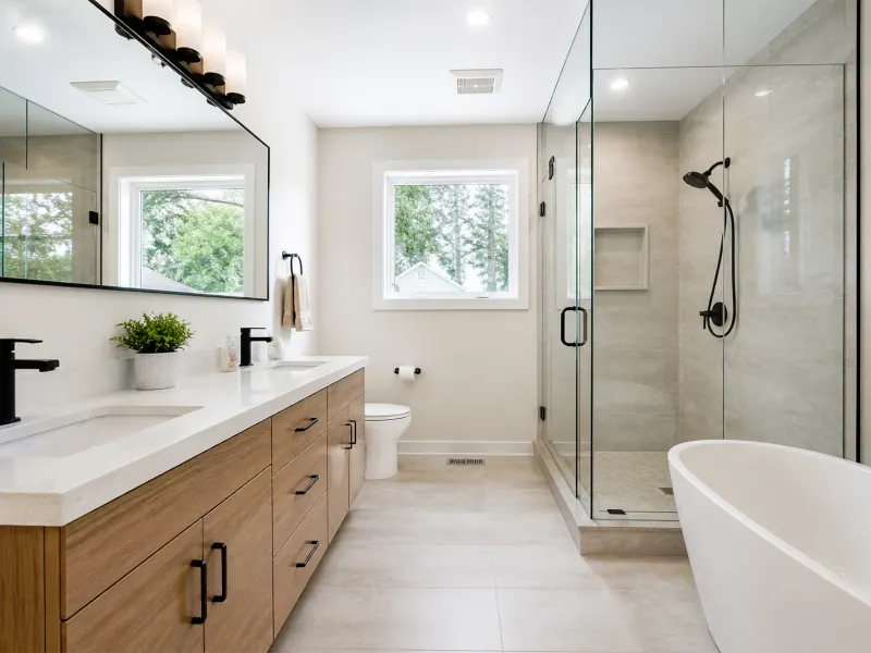 Clean Toronto bathroom renovation with walk-in shower, modern finishes, practical vanity storage, and improved lighting