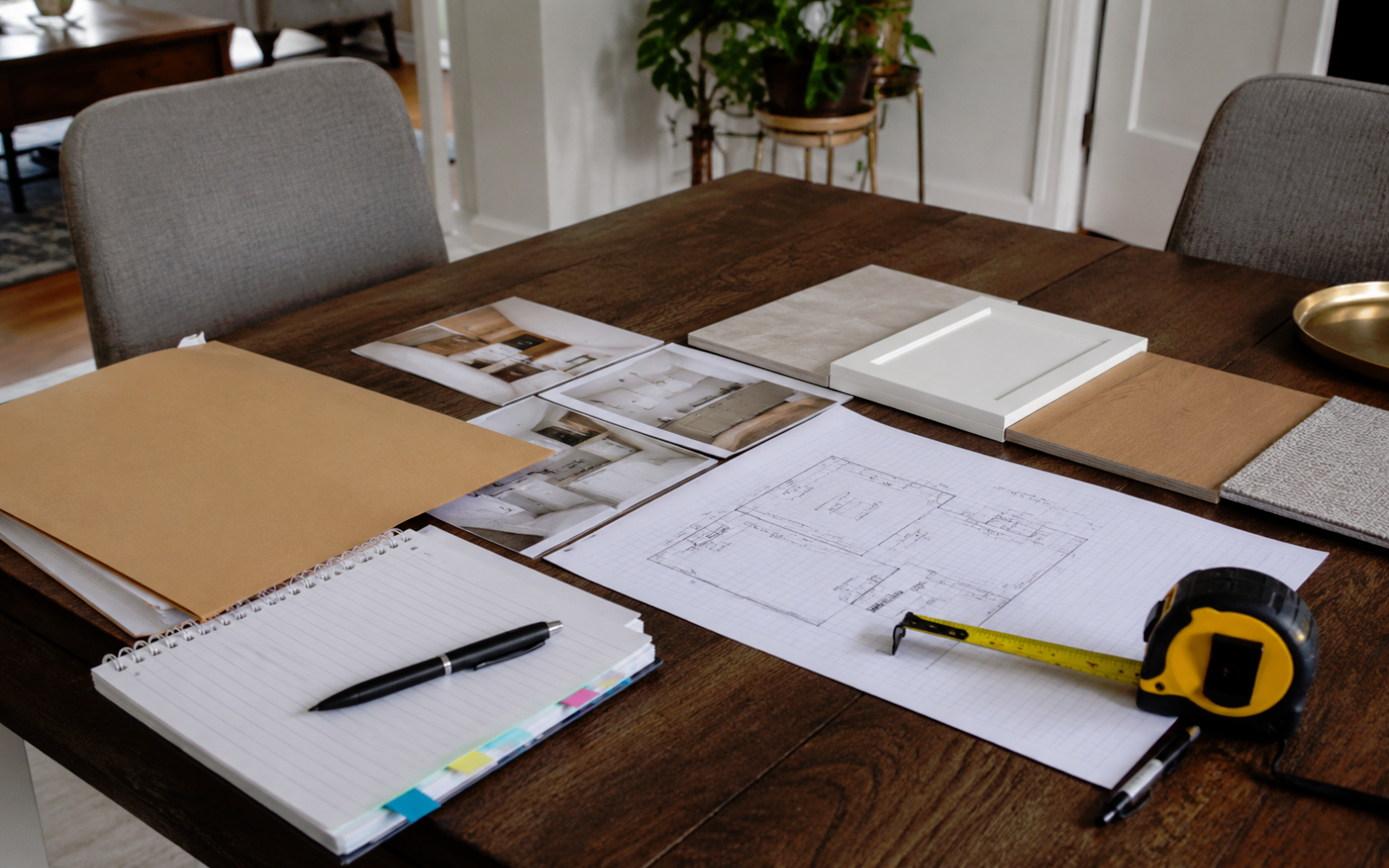 Renovation estimate checklist with floor sketch, notebook, measuring tape, inspiration photos, material samples, and planning folder in a Toronto home